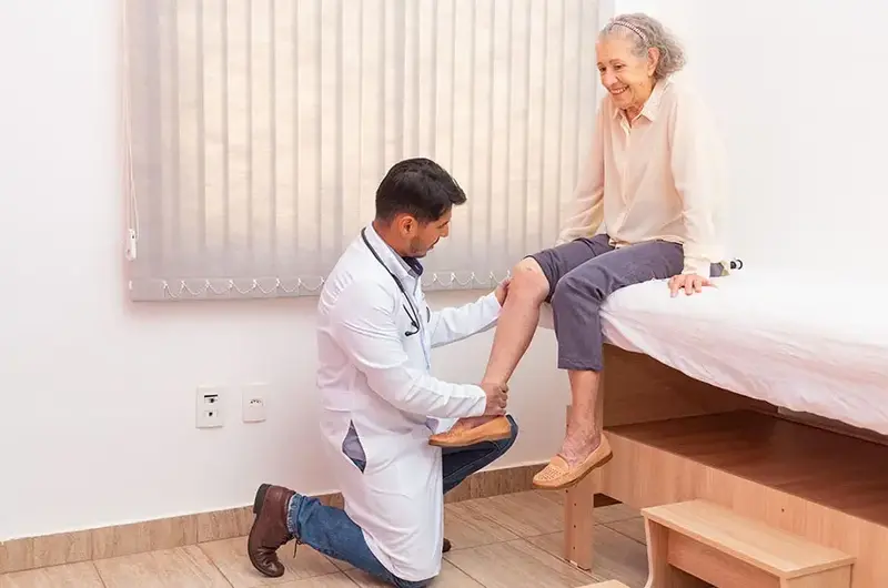 doctor-examining-female-patient-knee-joint-replacement