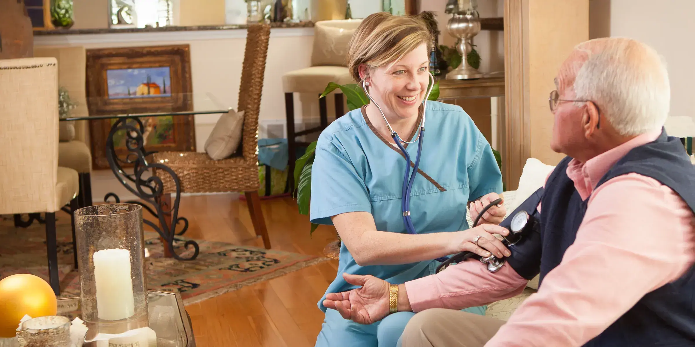Nurse with stethoscope older man visit home