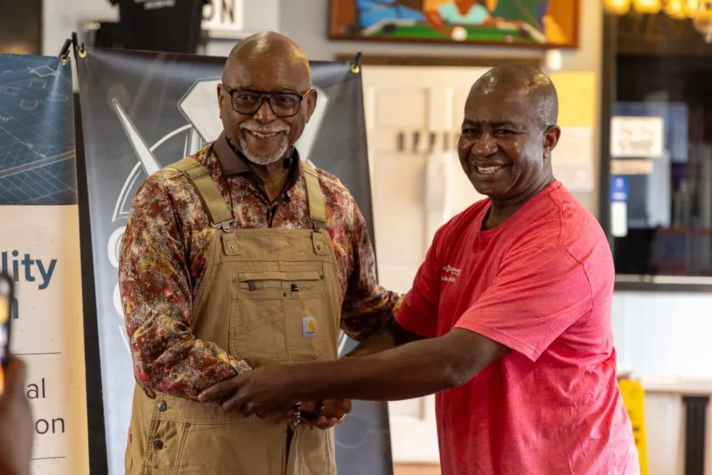 Thaddeus Bell shakes hands at barber shop