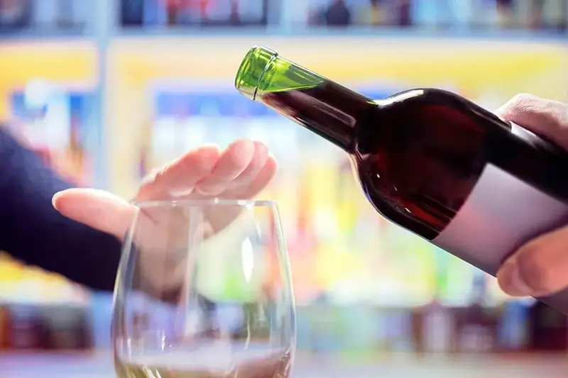 Womans hand rejecting alcohol no heavy winter drinking