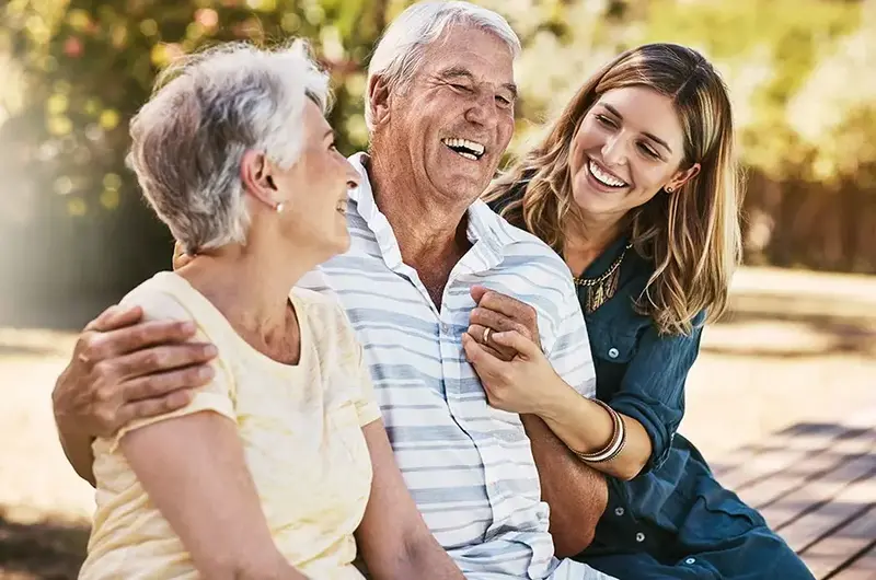 woman and grandparents hugging