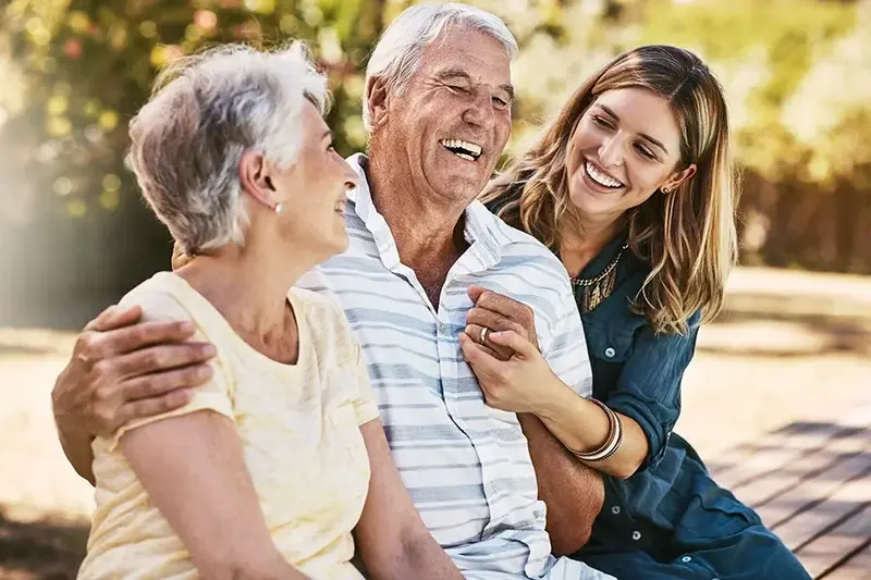 woman and grandparents hugging