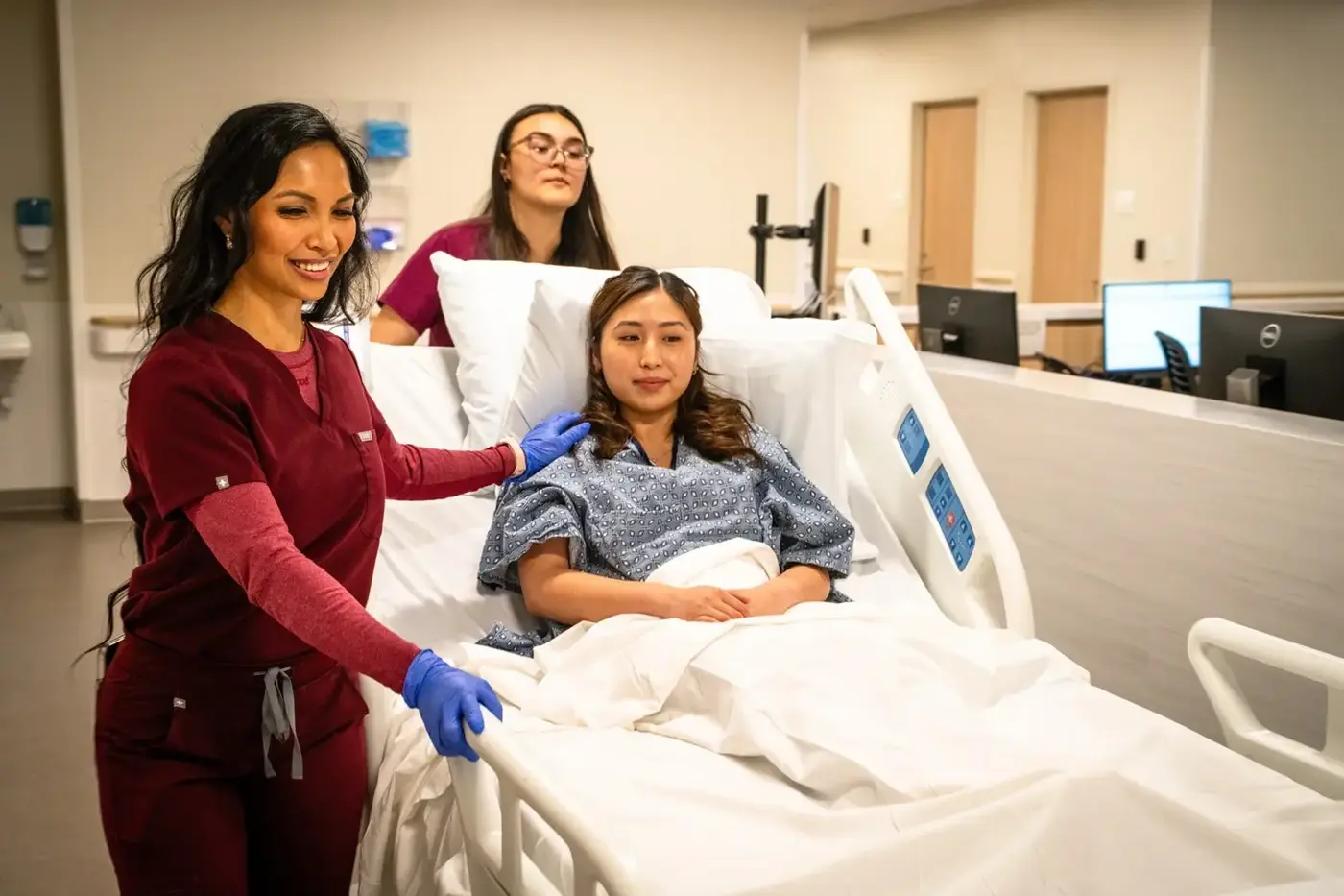 Nurses wheel patient to surgery