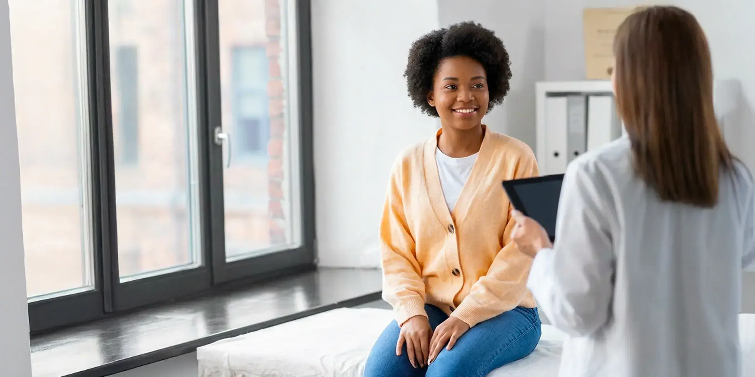 Doctor with female patient in room