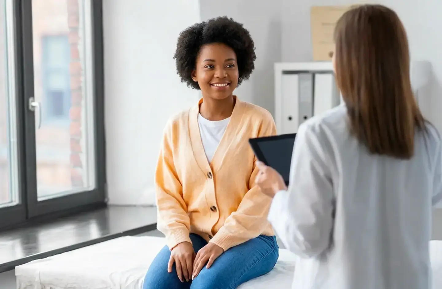 Doctor with female patient in room