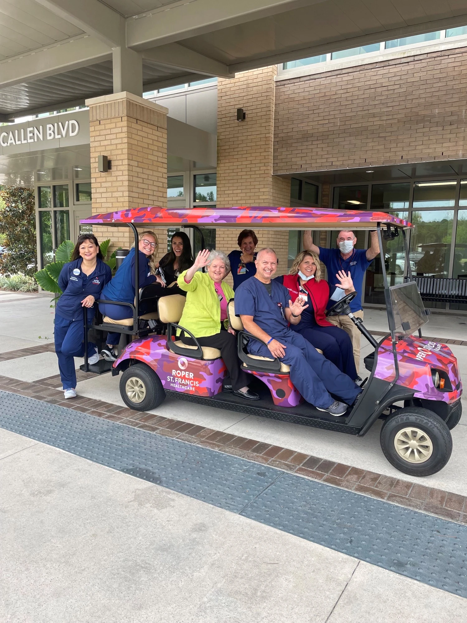 Roper teammates on golf cart