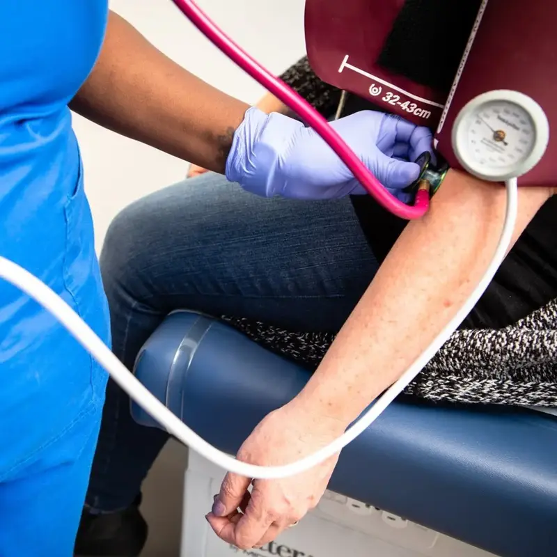 Nurse takes blood pressure