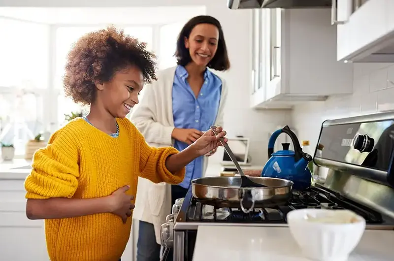 mom and daughter cooking together