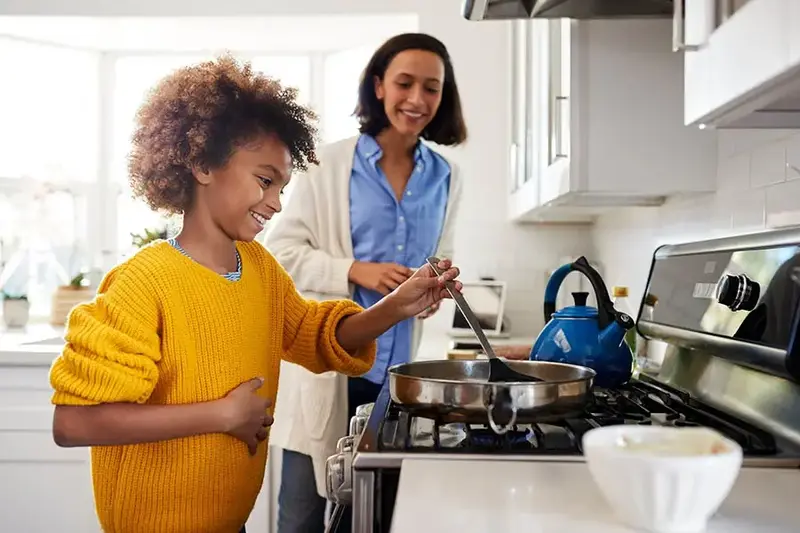 mom and daughter cooking together