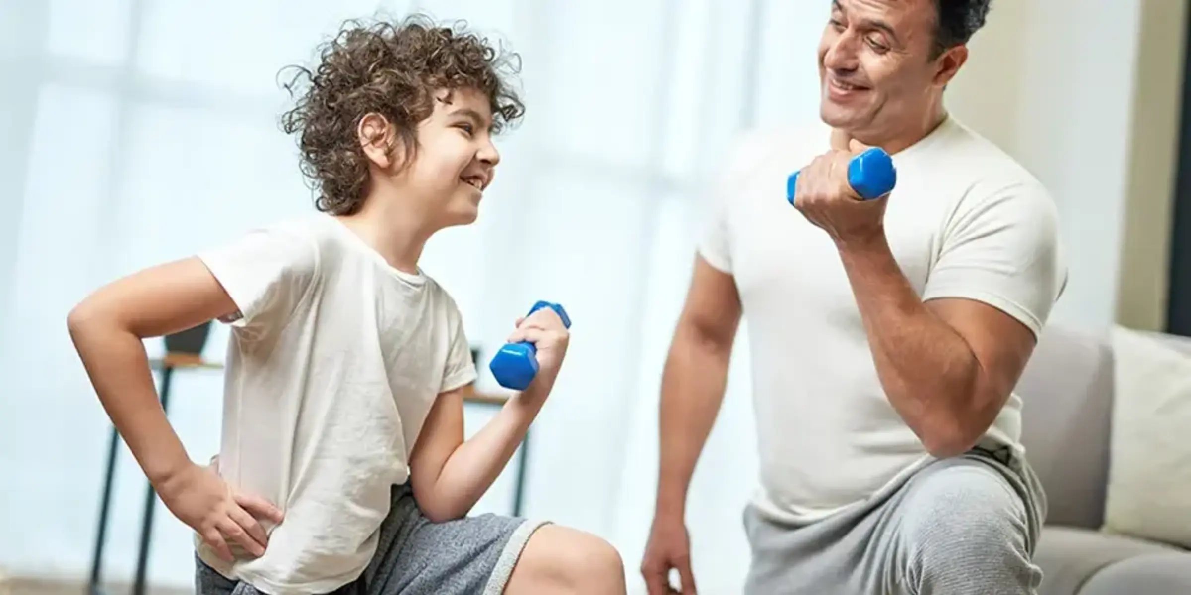 dad and son with dumbbells