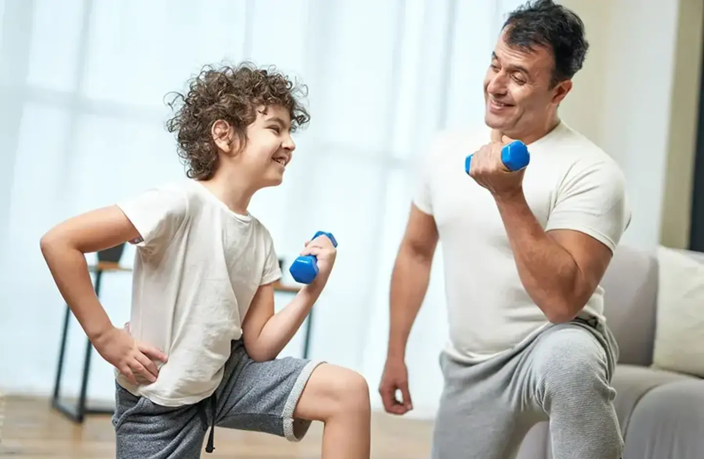 dad and son with dumbbells