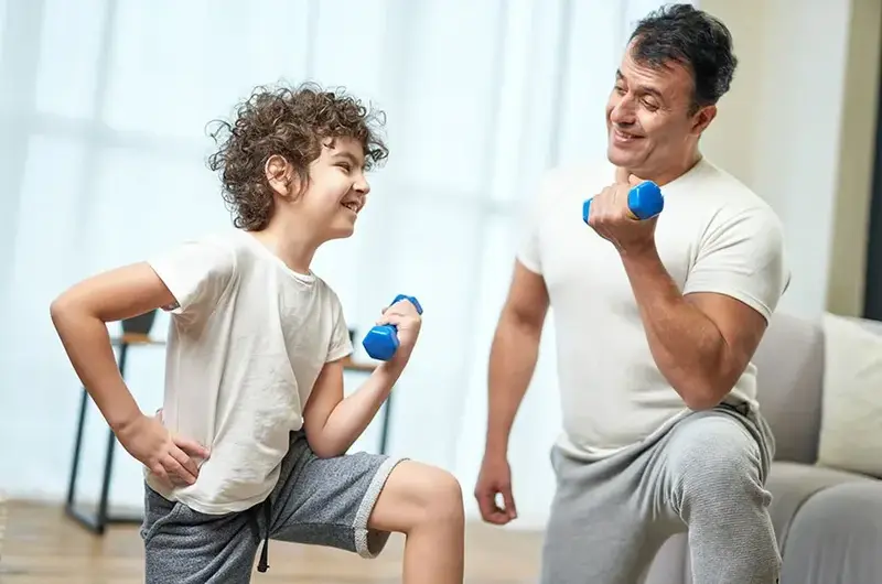 dad and son with dumbbells