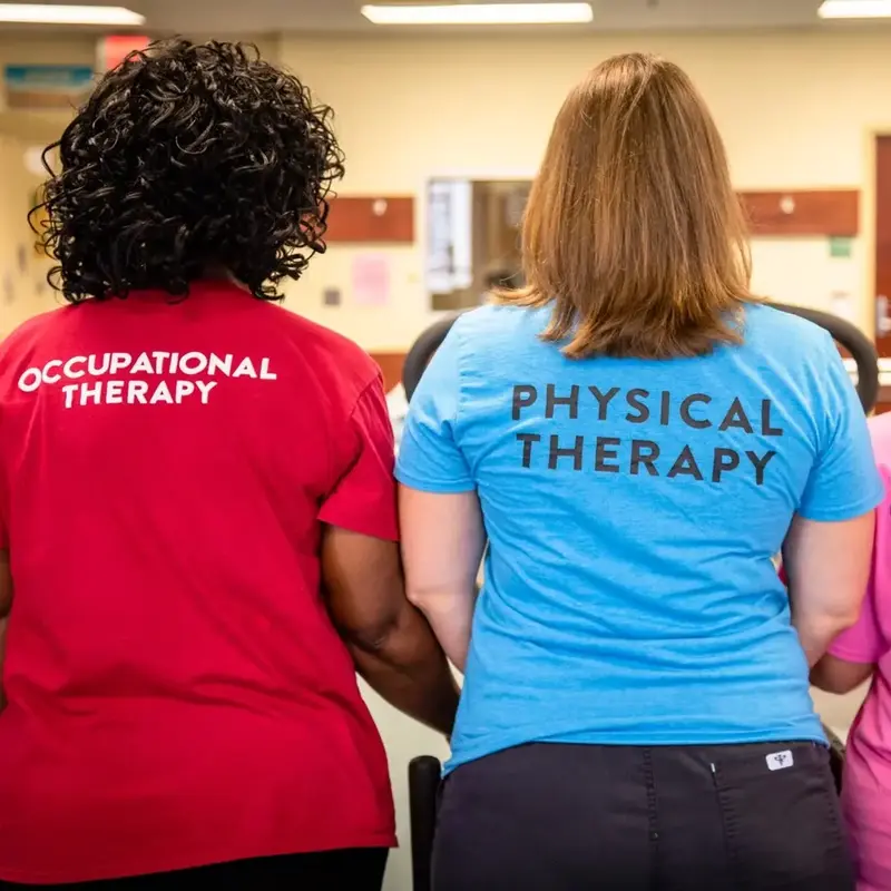 Physical therapists in labeled shirts