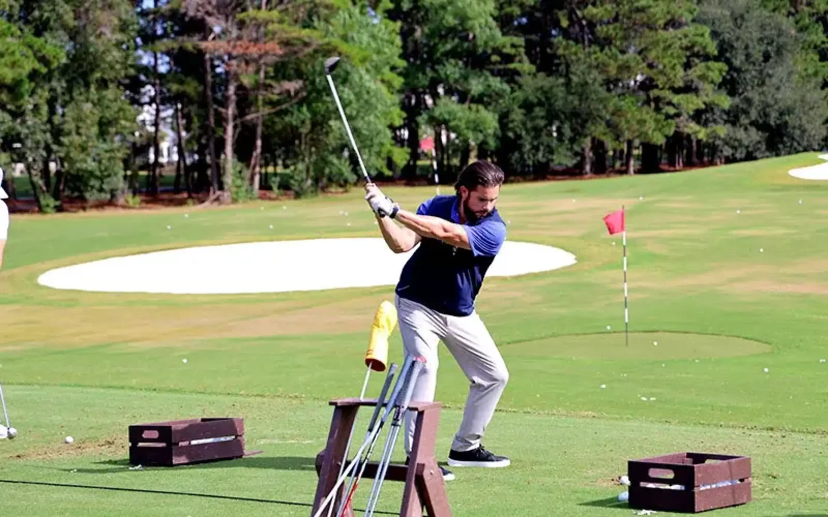 Man swings a golf club