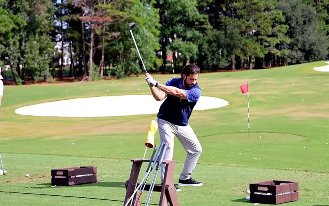 Man swings a golf club