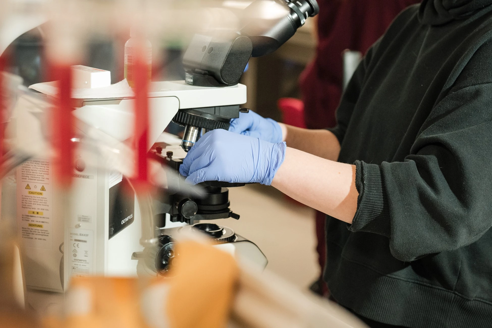 Lab tech uses microsope Lab tech uses microsope