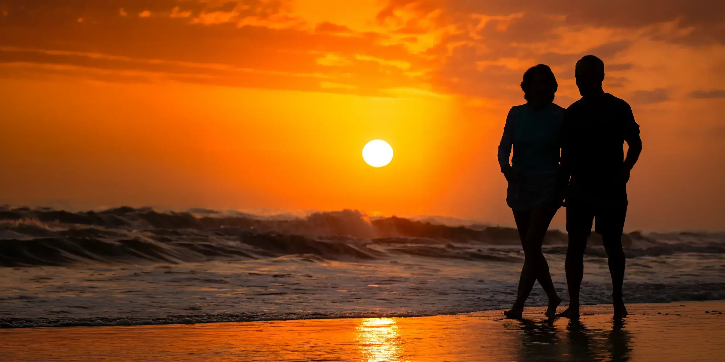 Couple on beach at sunset