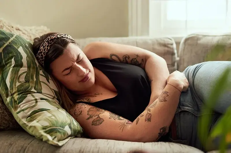 woman holding stomach with pain