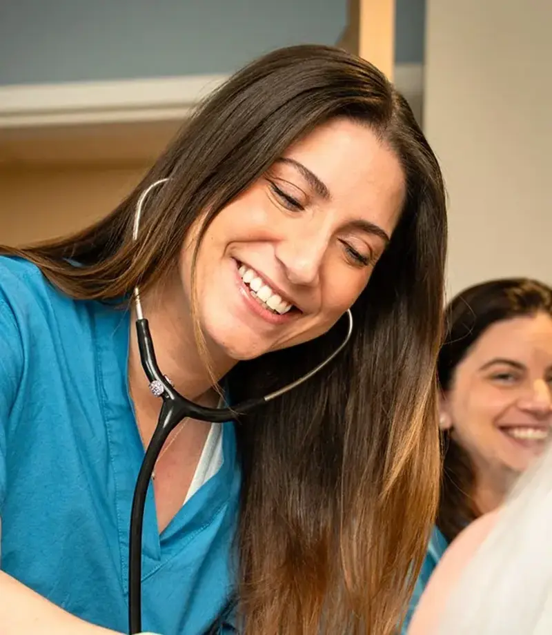 nurse listening to patient heart