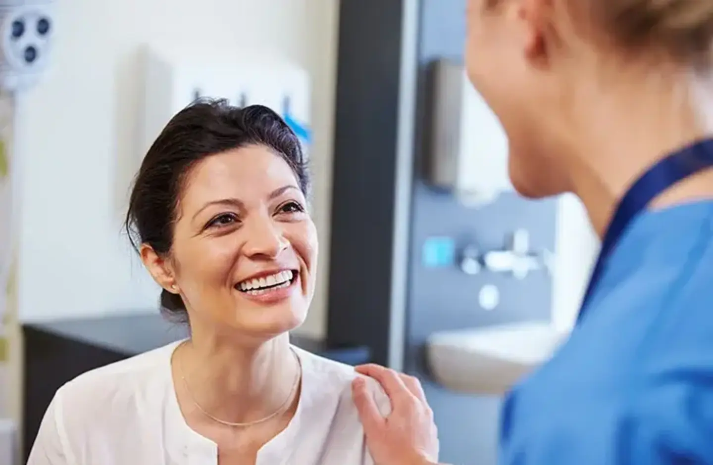 Nurse puts hand on patient shoulder