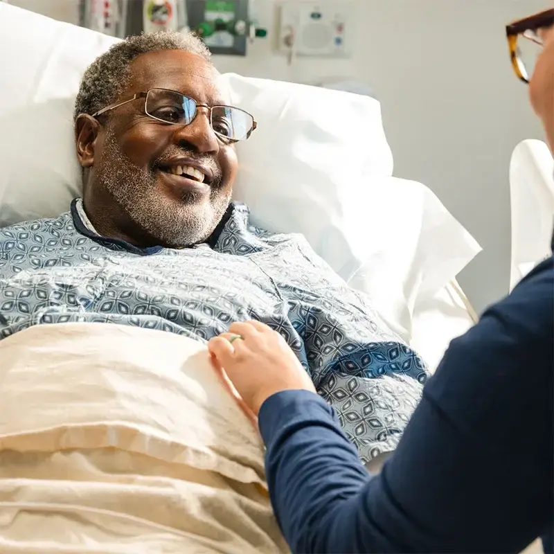 Man smiling in hospital bed