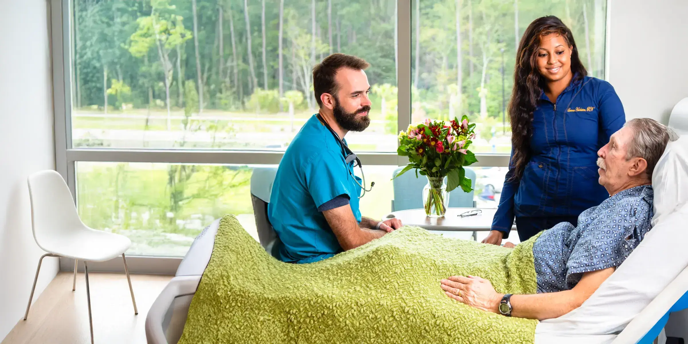Hospitalist and nurse at patient bedside