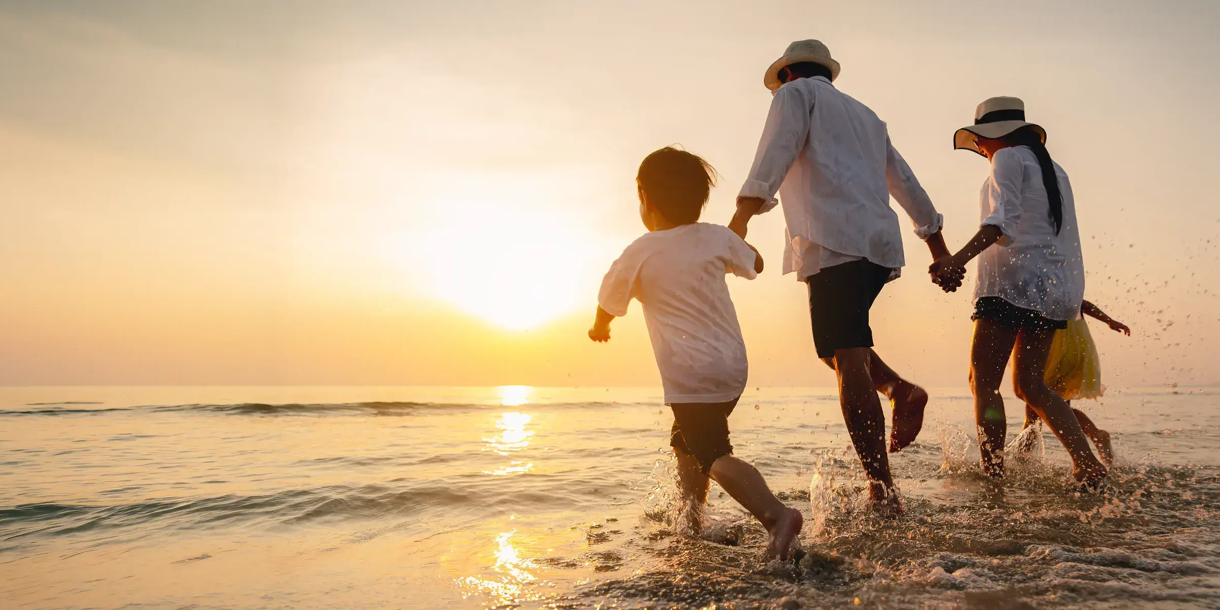 Family holding hands at beach