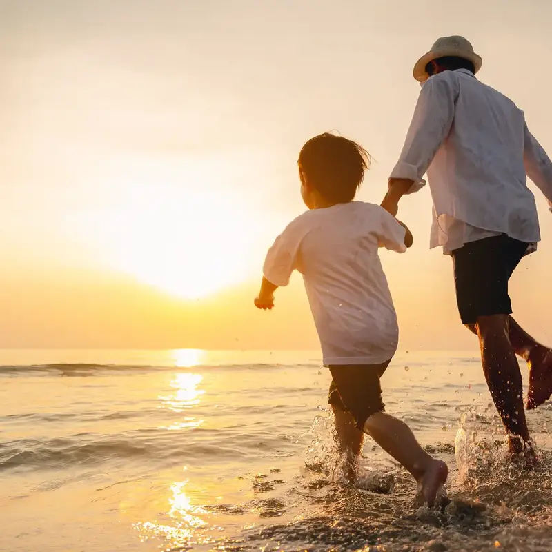 Family holding hands at beach