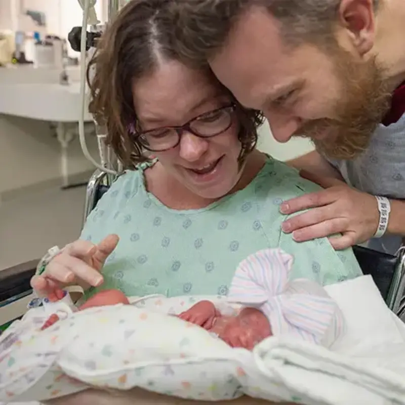 Mom, Dad and preemie baby in hospital