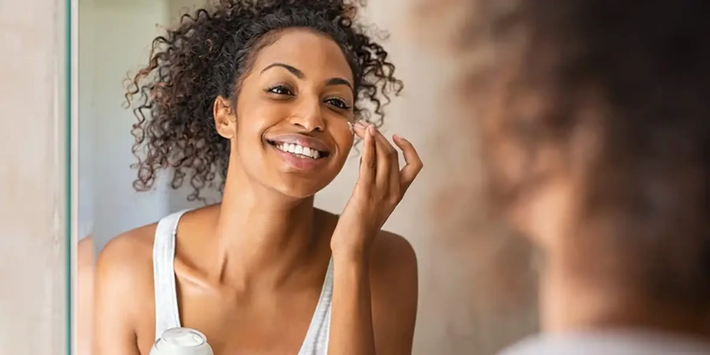 young girl moisturizing her skin