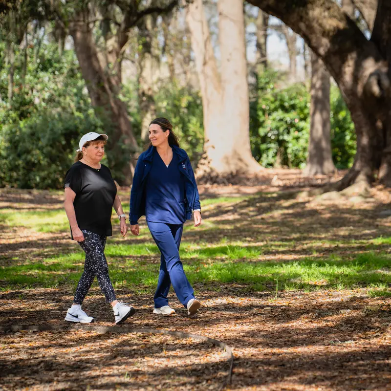 nurse and patient walking on trail
