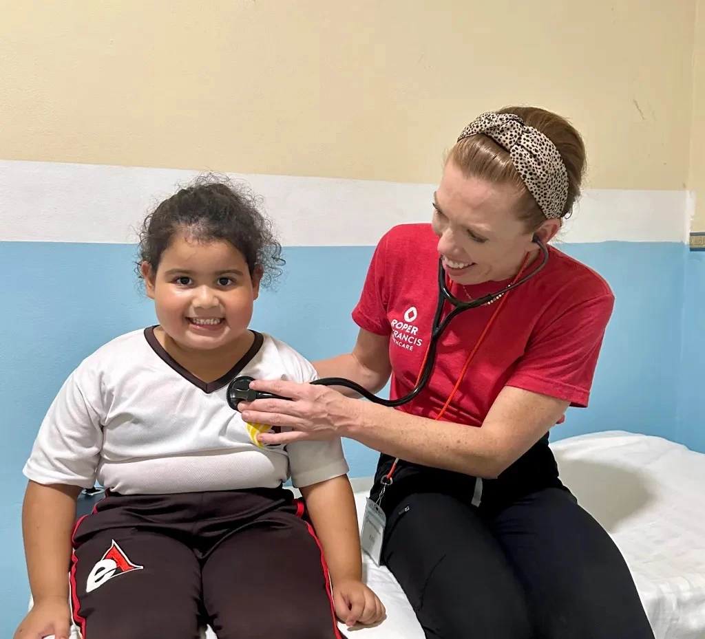 Kelly Guerrero PA with young girl patient