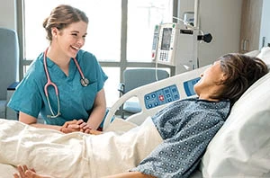 Berkeley hospital nurse at bedside with patient