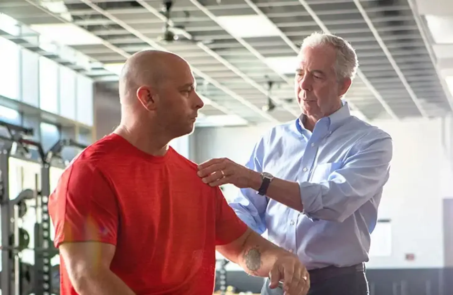 doctor examining patient shoulder