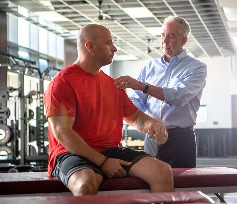 doctor examining patient shoulder