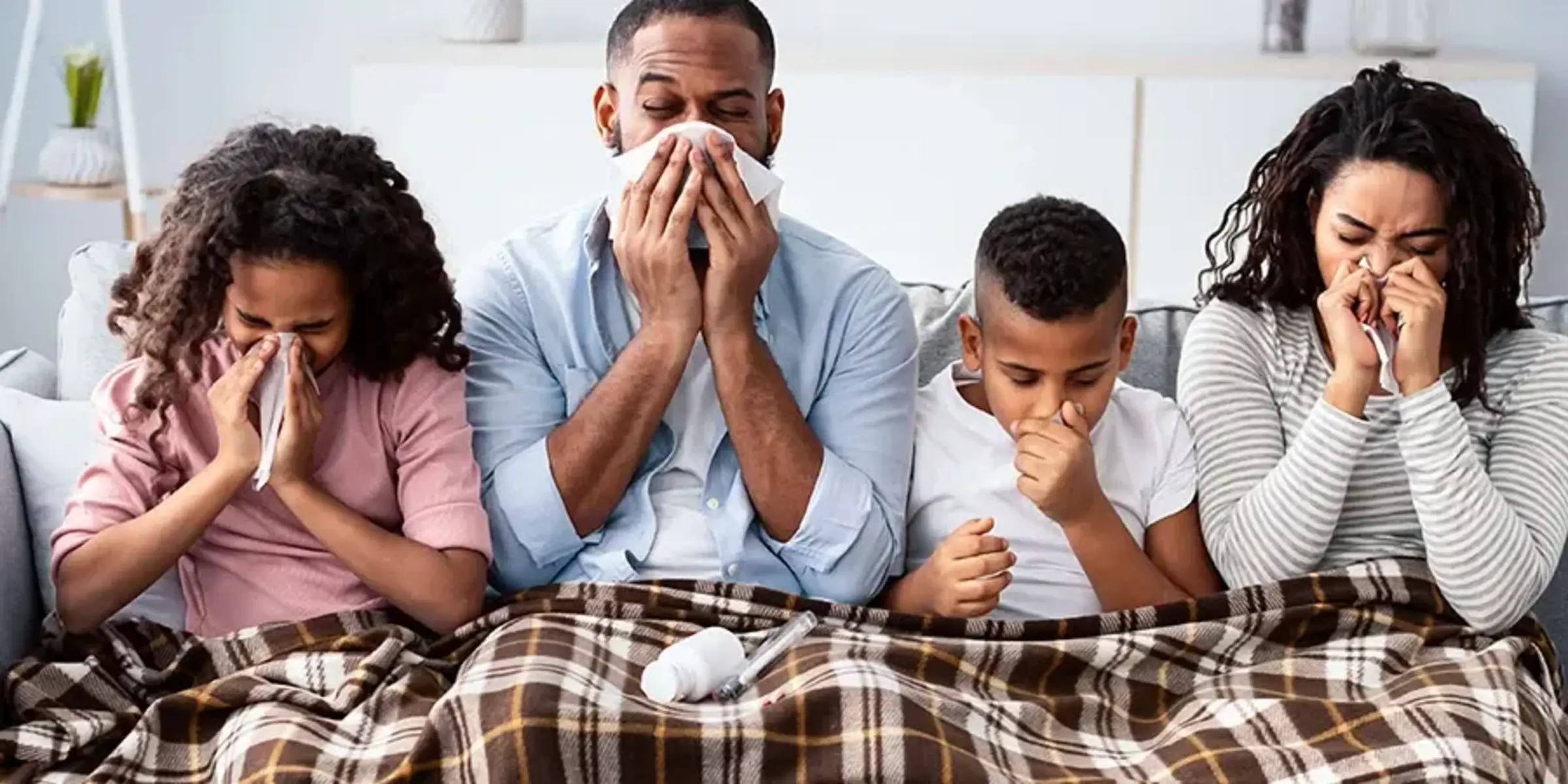 family sitting on the couch with the sniffles