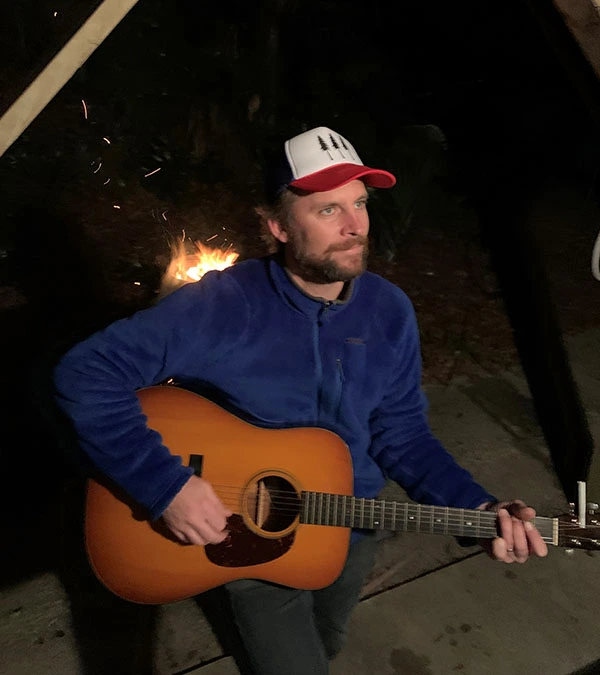 doctor lamb with guitar by campfire