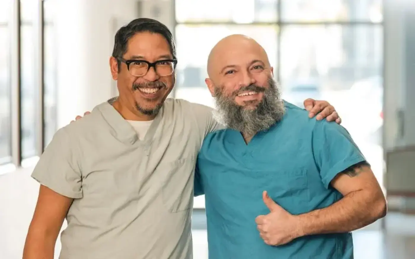 Male nurses give thumbs up