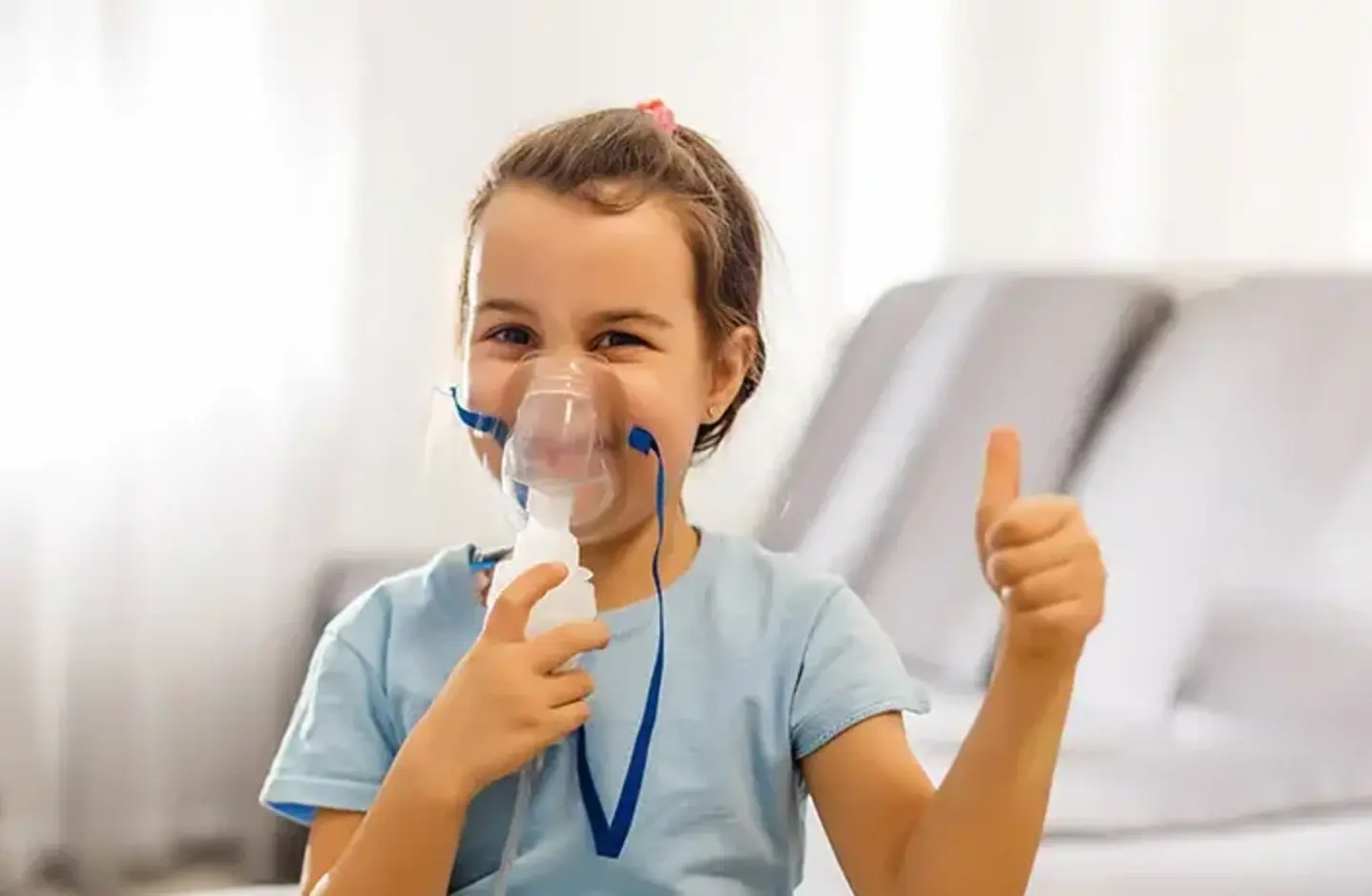 Child with asthma gives thumbs up