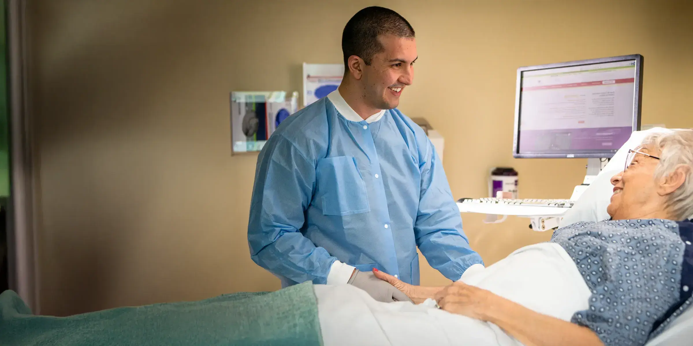 Older woman hospital bed male nurse