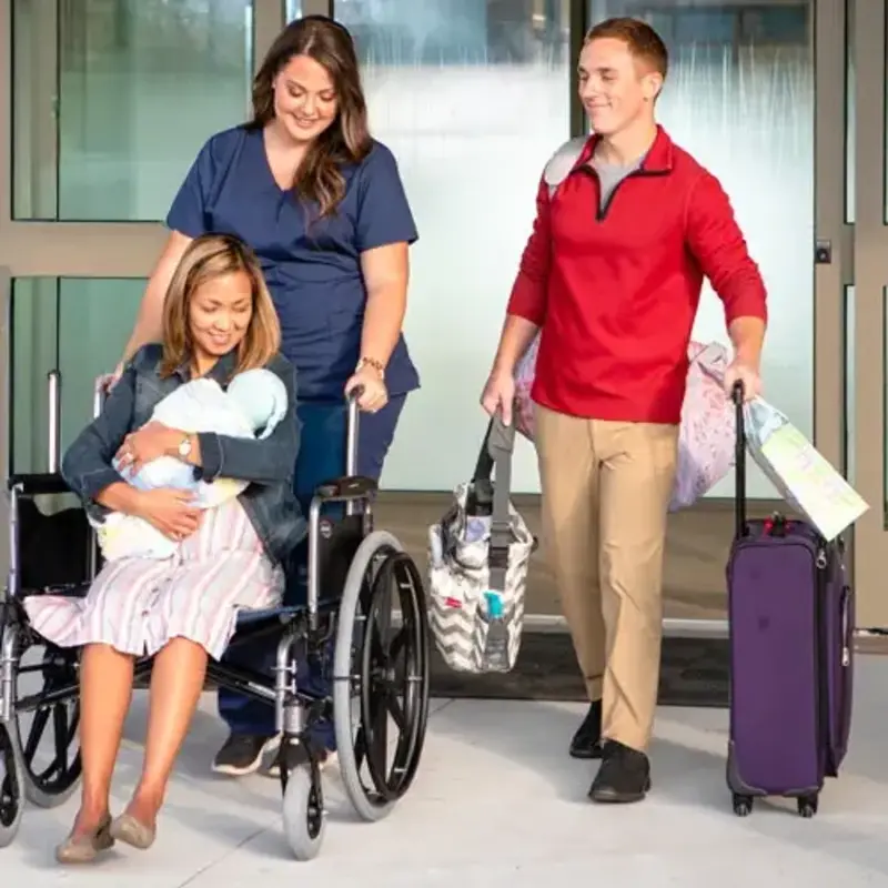 mom in wheelchair leaves hospital with dad and baby