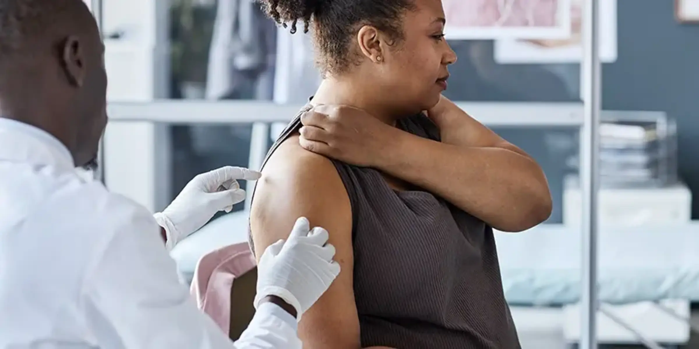 doctor looking at woman's skin