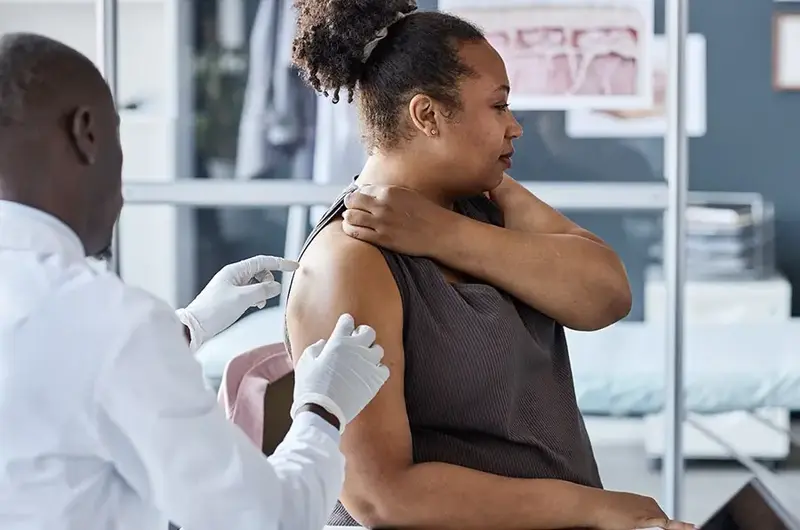 doctor looking at woman's skin