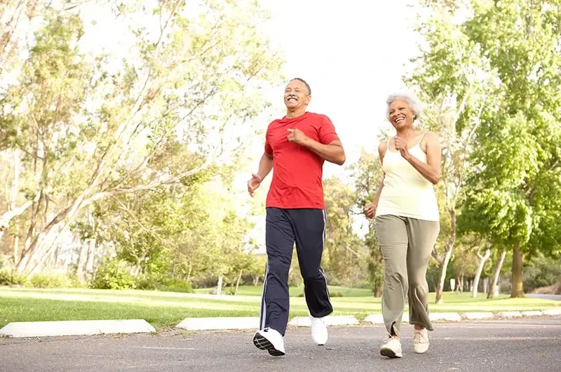 Senior Couple Jogging In Park