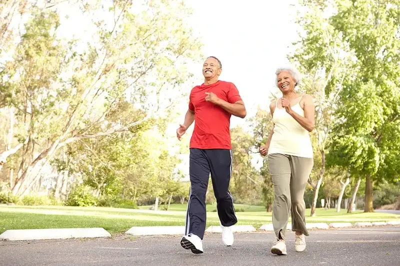 Senior Couple Jogging In Park