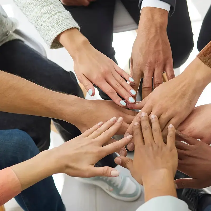 group of people stack hands