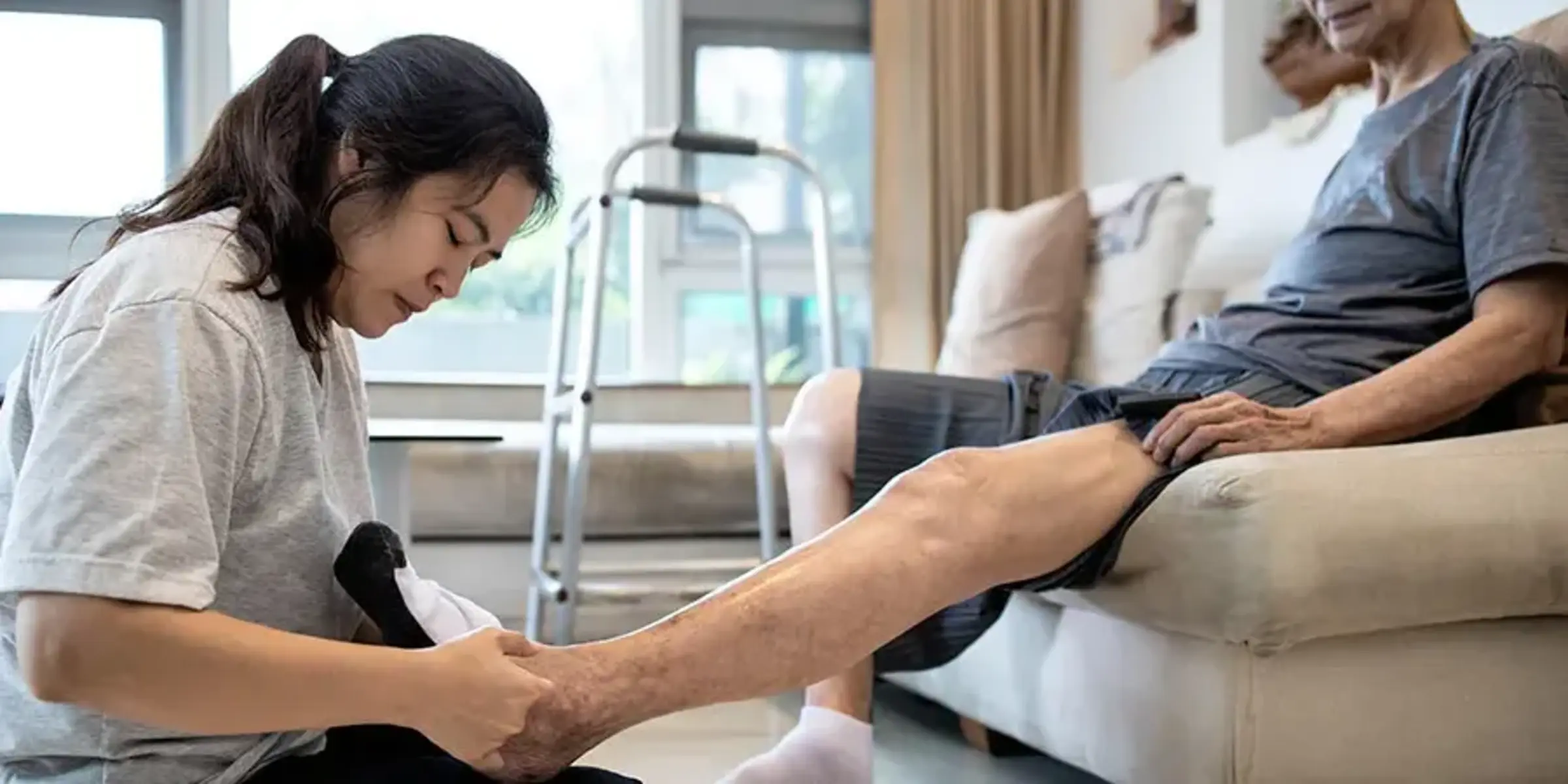 asian woman taking care of elderly man