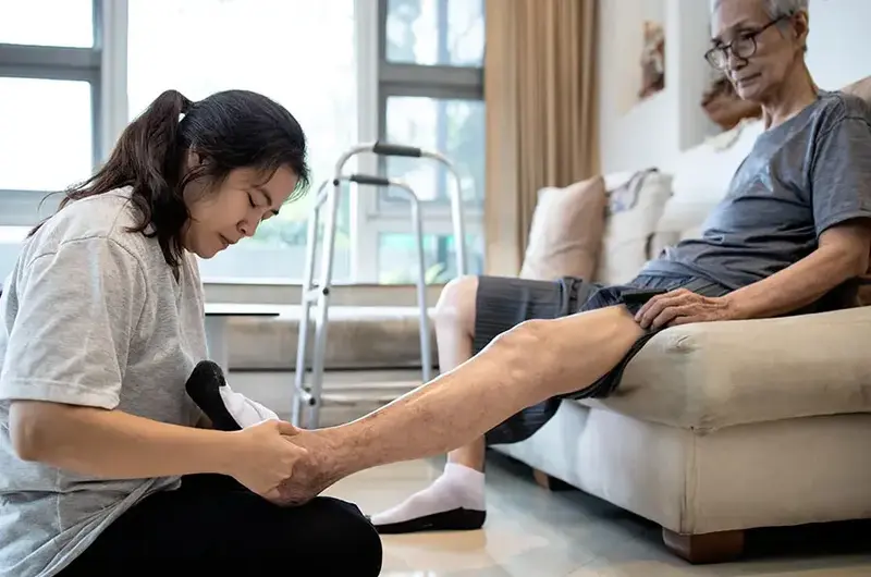 asian woman taking care of elderly man