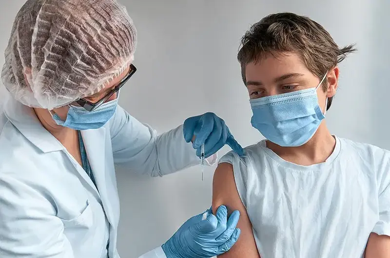 young boy getting vaccine