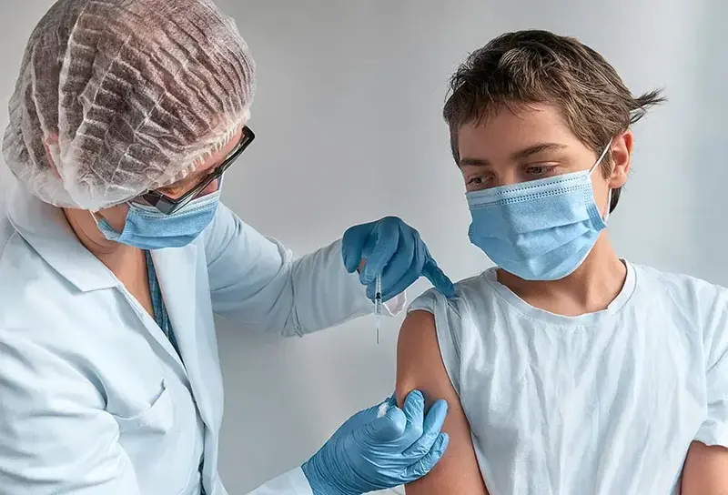 young boy getting vaccine